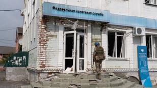 A Ukrainian soldier walks in front of a federal tax service center in Sudzha, in Russia's Kursk region, August 23, 2024, photo by Fabien Nachi/SOPA Images via Reuters